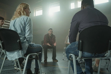 A view of group therapy in a session where one person is talking.